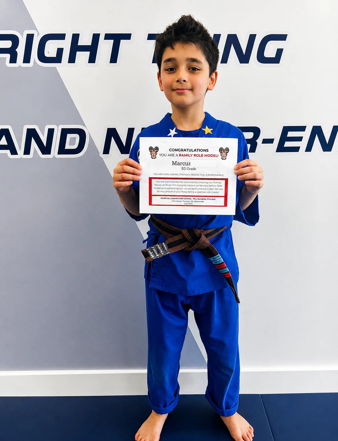 Confident young Excel Martial Arts student in a black uniform